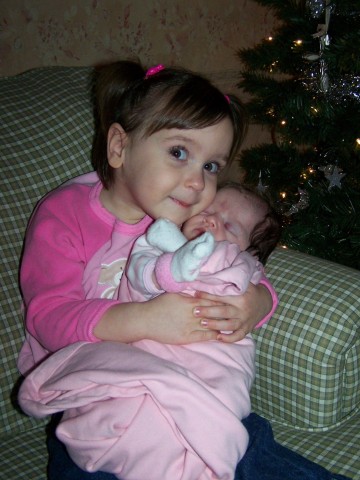 1st Time Maddie held Lila by herself.